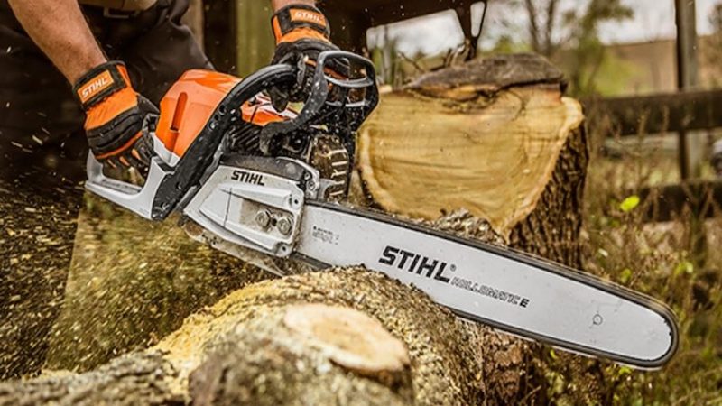 Person cutting wood with a chainsaw